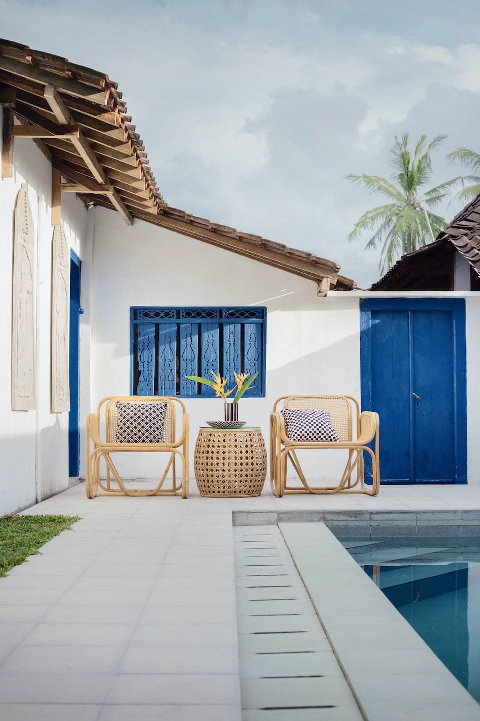 Standard Room exterior seating beside a pool